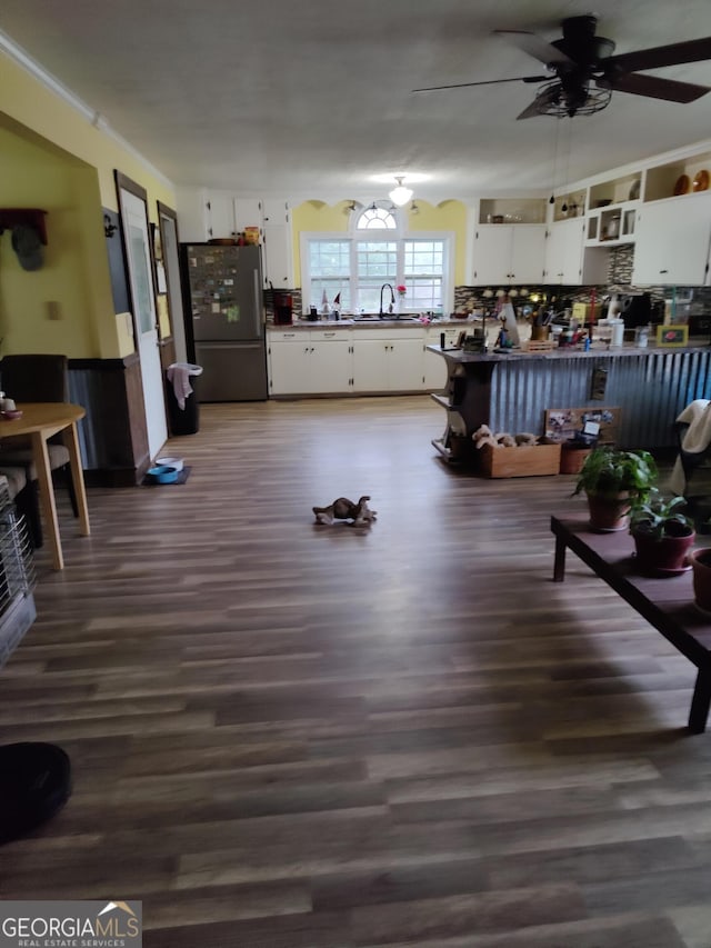 interior space with dark hardwood / wood-style floors, ceiling fan, and sink