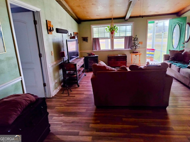 living room featuring vaulted ceiling with beams and dark hardwood / wood-style floors