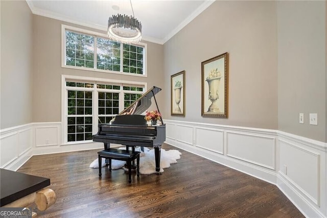 misc room with dark hardwood / wood-style floors, a chandelier, and ornamental molding