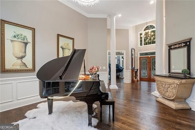 misc room with decorative columns, dark hardwood / wood-style flooring, crown molding, and french doors