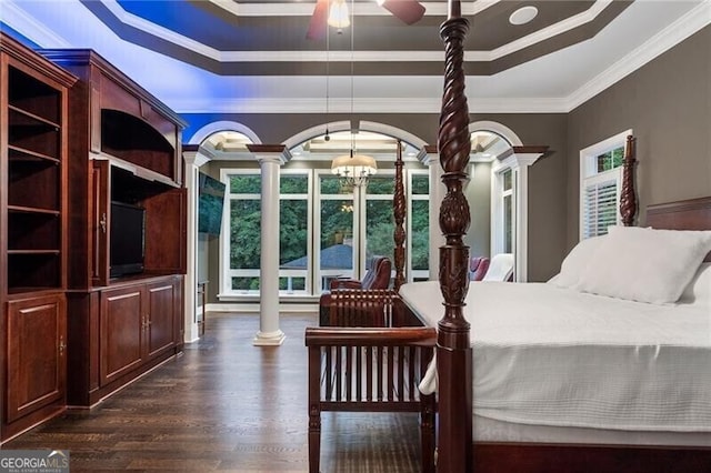 bedroom featuring decorative columns, crown molding, a raised ceiling, and ceiling fan with notable chandelier