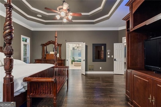 bedroom with ceiling fan, dark wood-type flooring, a tray ceiling, and crown molding