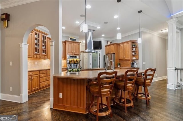 kitchen with backsplash, appliances with stainless steel finishes, ornamental molding, and pendant lighting