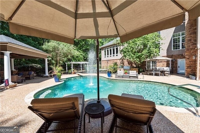 view of swimming pool featuring a gazebo, a patio area, and pool water feature