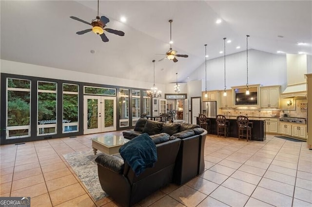 living room featuring high vaulted ceiling, french doors, light tile patterned flooring, and ceiling fan