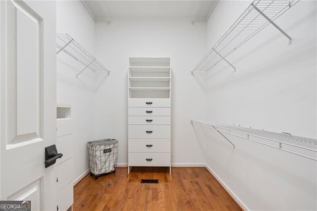 walk in closet featuring hardwood / wood-style flooring