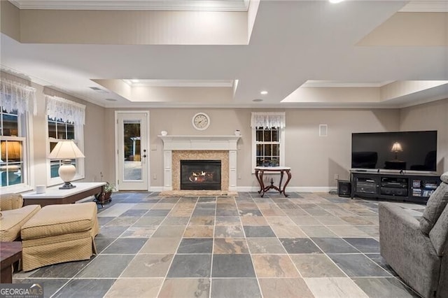 living room with a tray ceiling and crown molding