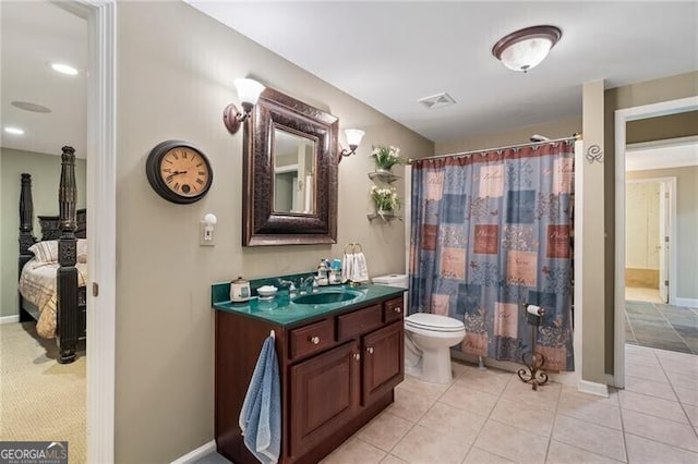 bathroom with tile patterned floors, vanity, and toilet