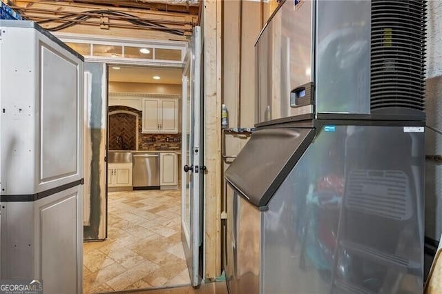 kitchen featuring decorative backsplash, heating unit, and dishwasher