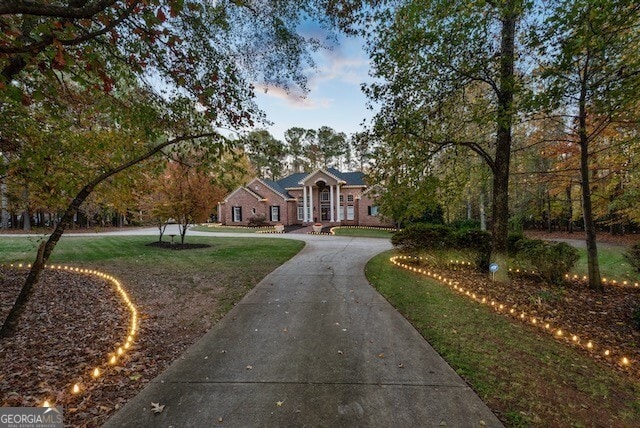 ranch-style home with a lawn