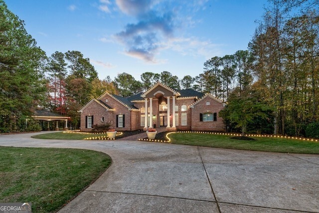 mediterranean / spanish-style home with a front lawn