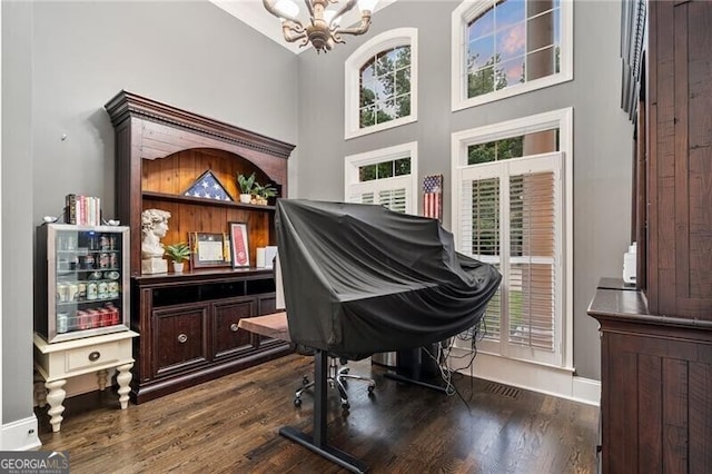 miscellaneous room featuring dark hardwood / wood-style flooring and an inviting chandelier