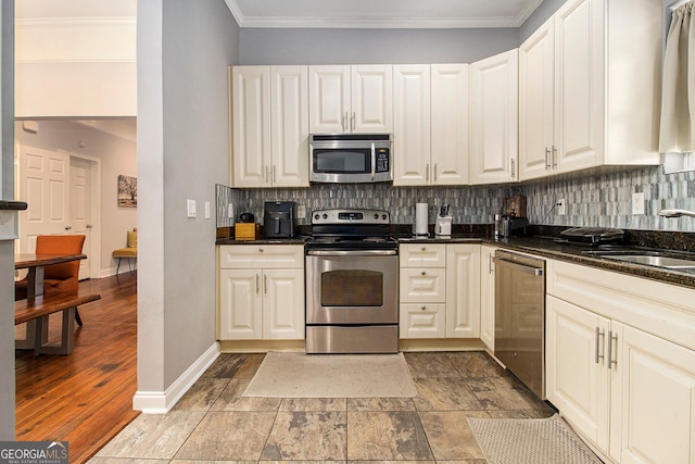 kitchen featuring decorative backsplash, light hardwood / wood-style floors, sink, and appliances with stainless steel finishes