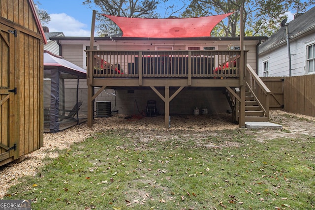 back of house featuring central air condition unit, a yard, and a deck