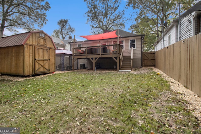 view of yard with a deck and a storage shed