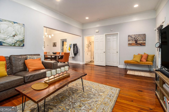 living room with dark hardwood / wood-style floors and ornamental molding