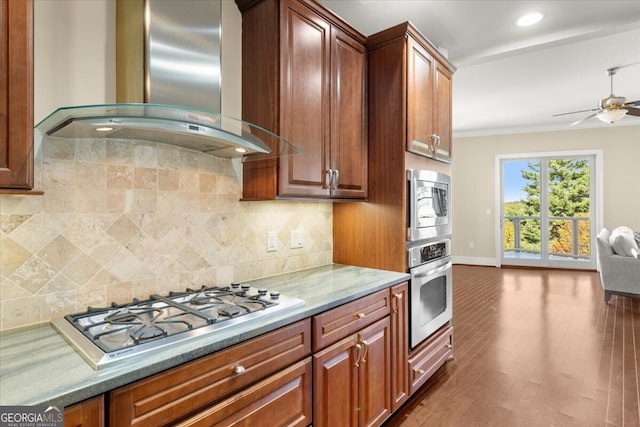 kitchen with backsplash, dark wood-type flooring, wall chimney exhaust hood, and stainless steel appliances