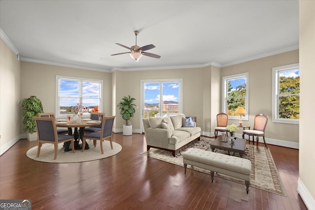 living room with ceiling fan, a healthy amount of sunlight, ornamental molding, and dark wood-type flooring