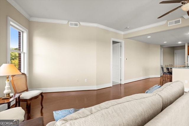 living room featuring crown molding, hardwood / wood-style floors, and ceiling fan