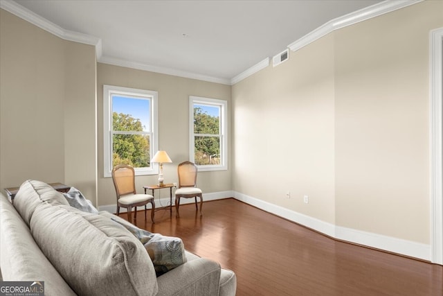 living area with dark hardwood / wood-style flooring and ornamental molding