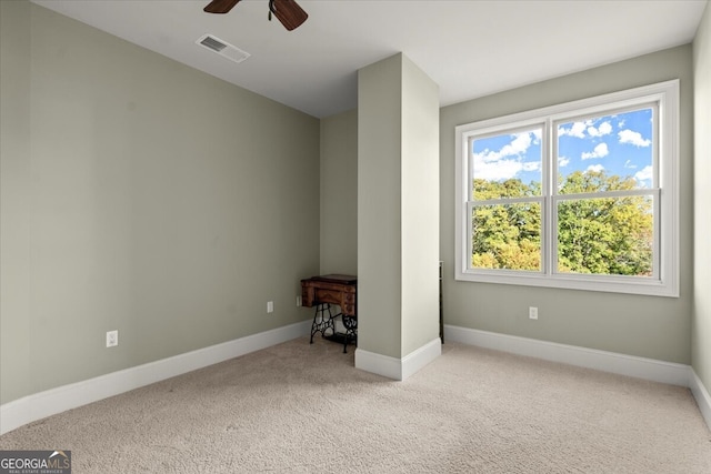 carpeted empty room featuring ceiling fan