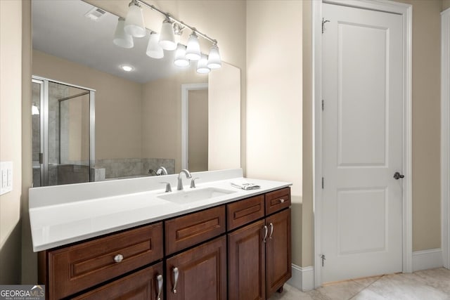 bathroom featuring vanity, tile patterned floors, and walk in shower