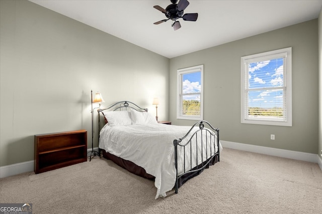 bedroom featuring carpet floors, vaulted ceiling, and ceiling fan