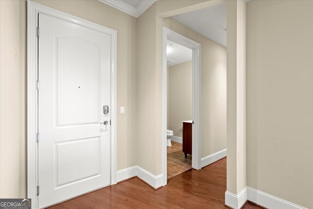 entryway featuring hardwood / wood-style floors and ornamental molding