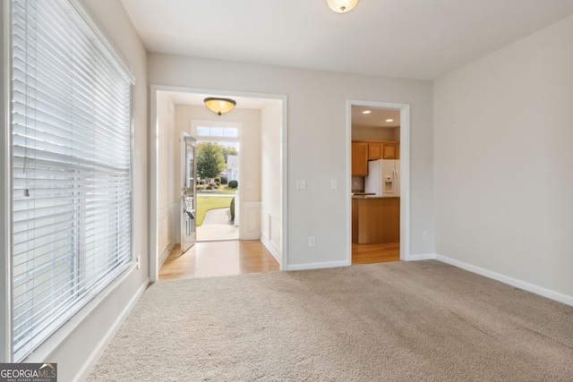 unfurnished room with light carpet