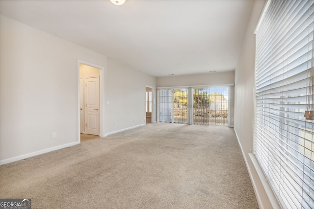 unfurnished living room featuring light colored carpet