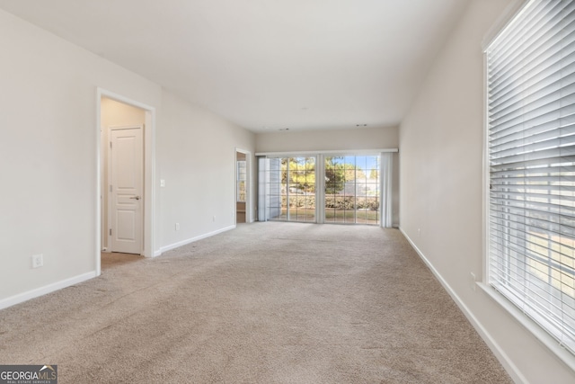 unfurnished living room featuring light carpet