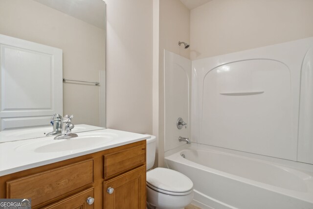 full bathroom with toilet, vanity, and washtub / shower combination