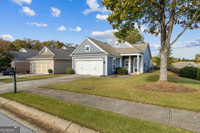 view of front of property with a front lawn, a garage, and central AC