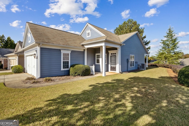 view of front of house featuring a front yard, a porch, a garage, and central AC unit