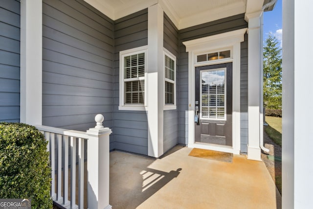 view of exterior entry featuring a porch