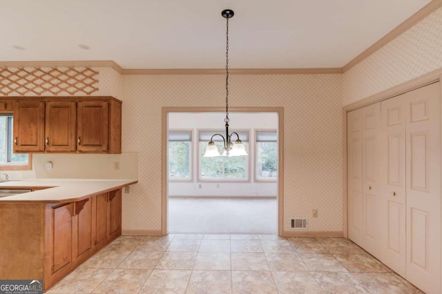 kitchen with ornamental molding, hanging light fixtures, light tile patterned floors, and an inviting chandelier