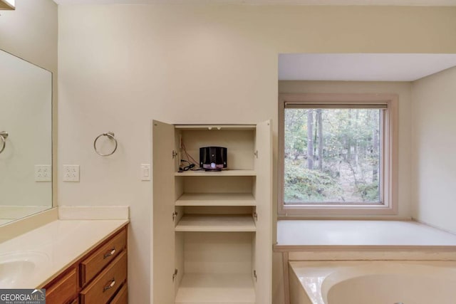 bathroom featuring a tub and vanity