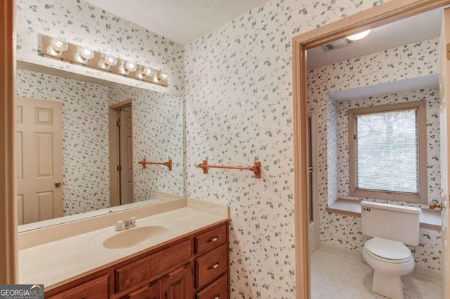 bathroom with vanity, tile patterned floors, a textured ceiling, and toilet