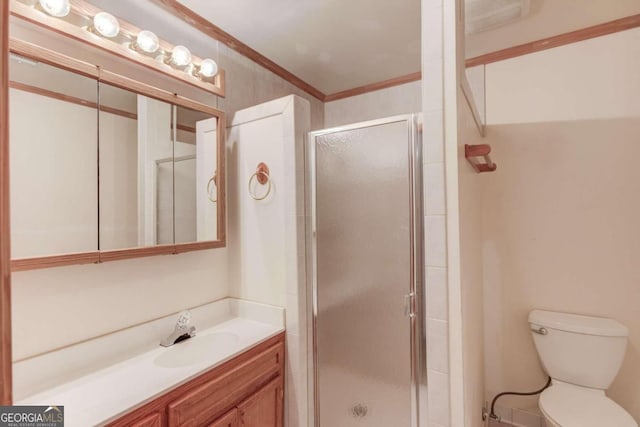 bathroom featuring vanity, toilet, walk in shower, and ornamental molding