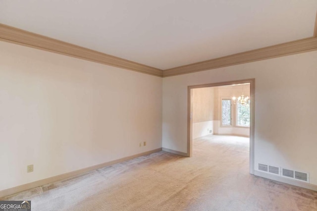 unfurnished room with light carpet, an inviting chandelier, and ornamental molding