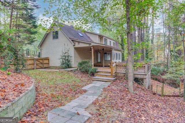 view of front of home with ceiling fan and a wooden deck