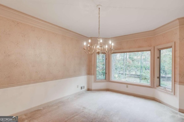 carpeted spare room with an inviting chandelier and ornamental molding