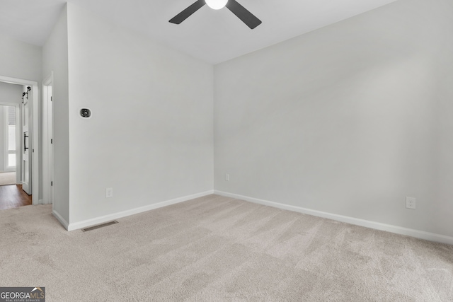 empty room featuring light carpet and ceiling fan