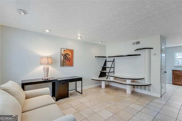 tiled living room with a textured ceiling