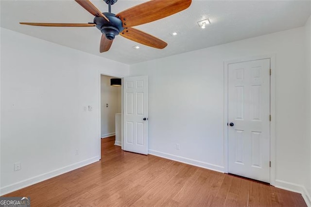 unfurnished room with light hardwood / wood-style flooring and ceiling fan