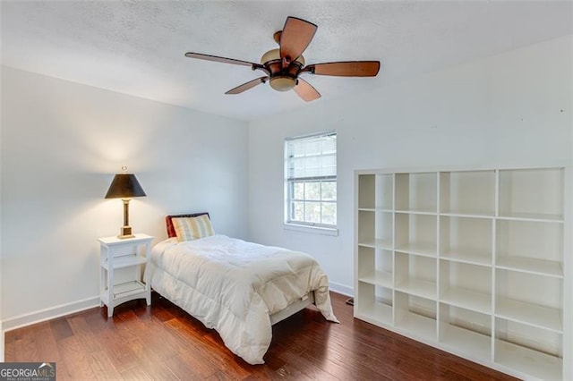 bedroom featuring ceiling fan and dark hardwood / wood-style floors