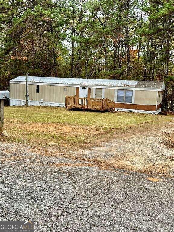 view of front of property featuring a front yard and a wooden deck