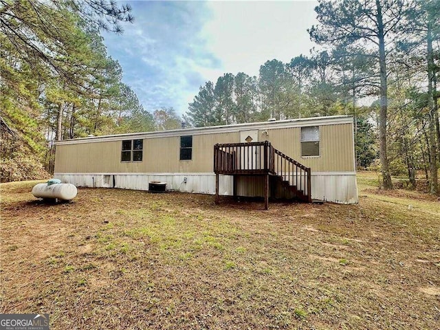 back of property featuring a wooden deck