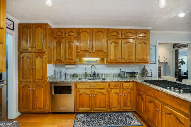 kitchen with sink, stainless steel dishwasher, gas stovetop, light wood-type flooring, and ornamental molding