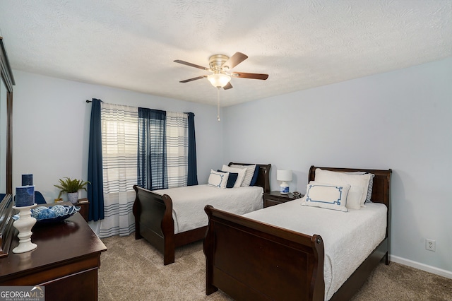 carpeted bedroom with a textured ceiling and ceiling fan